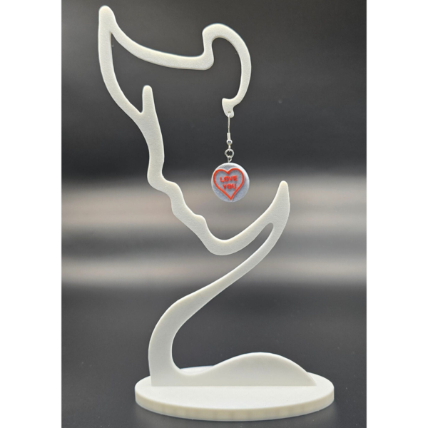 pair of love heart earrings on display stand