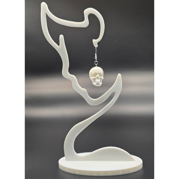 pair of skull earrings on display stand